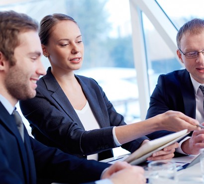 Business men and women working around a table